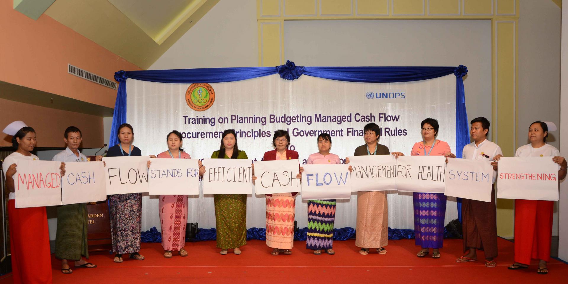 MOHS Yangon Regional Deputy Director (Disease Control) Dr Khin Nan Lon, together with participating government health staff and UNOPS-PR staff, promoting effective and efficient cash flow management for health system strengthening in Myanmar. Photo: UNOPS