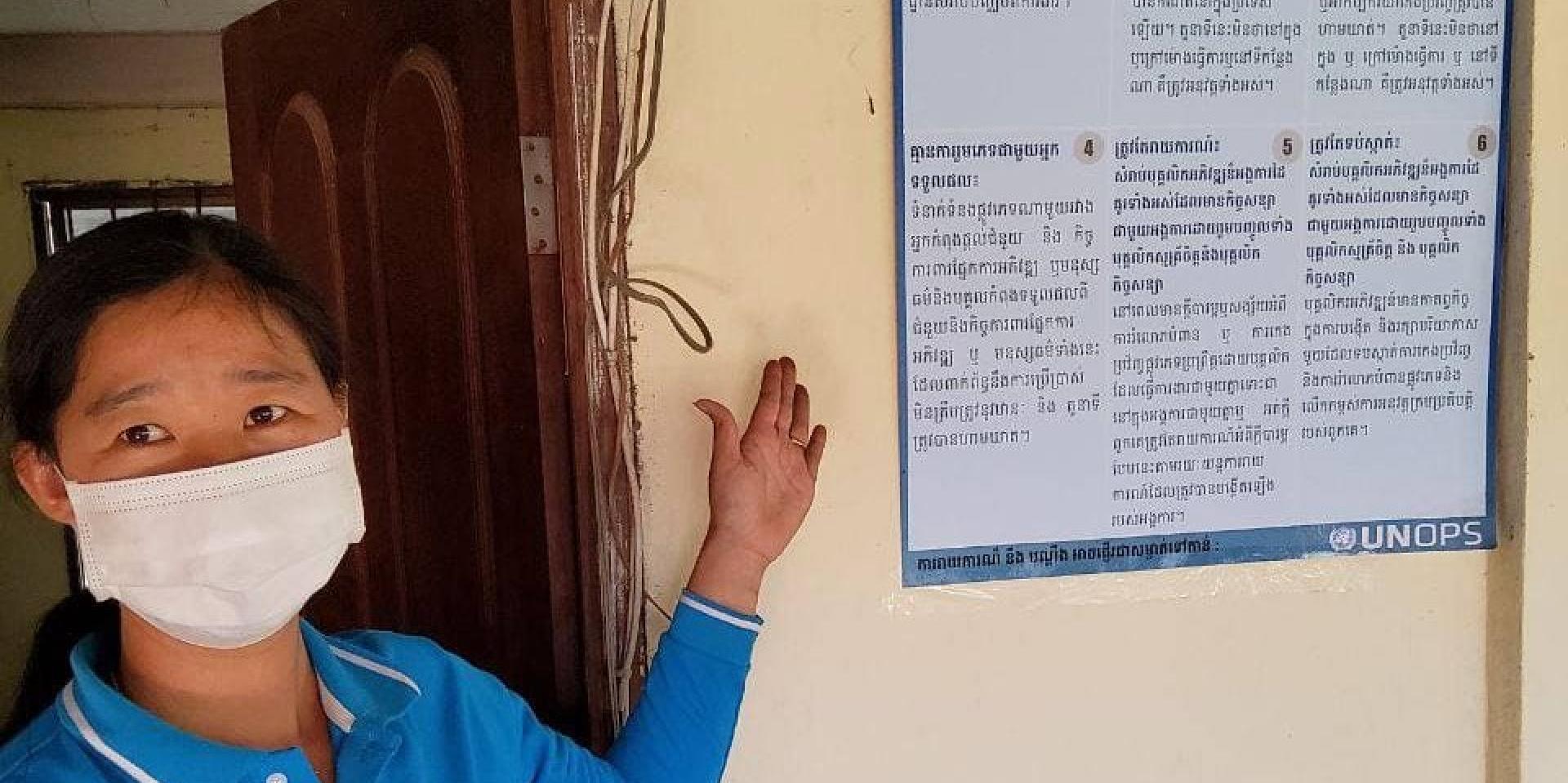 A Catholic Relief Services (CRS) staff-member explains PSEA principles in the PSEA poster at the CRS office in Preah Vihear Province, Cambodia ©Catholic Relief Services