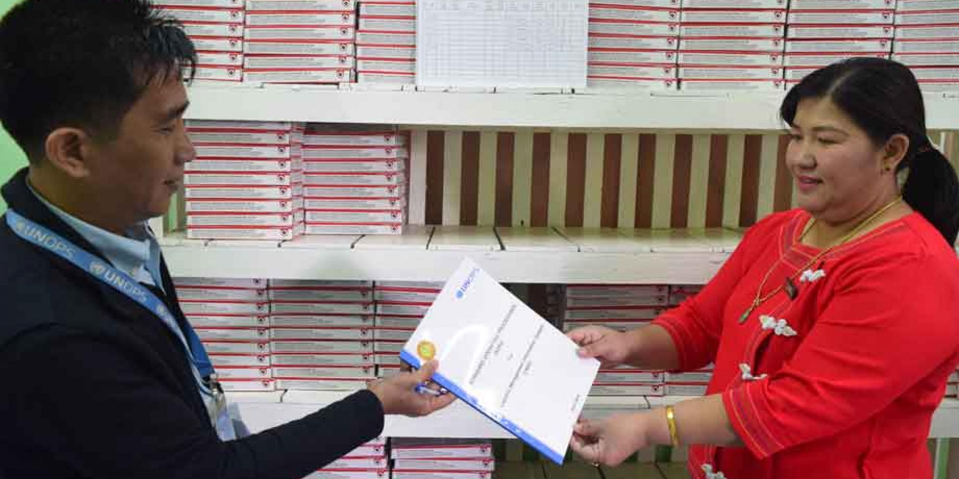 Store in-charge Daw M Nang Jar at Taunggyi NTP is given the updated Logistics Management Information System manual. The logistics support helps ensure that standard logistics manuals are in place at every storage facility of partners implementing the Global Fund grants.
