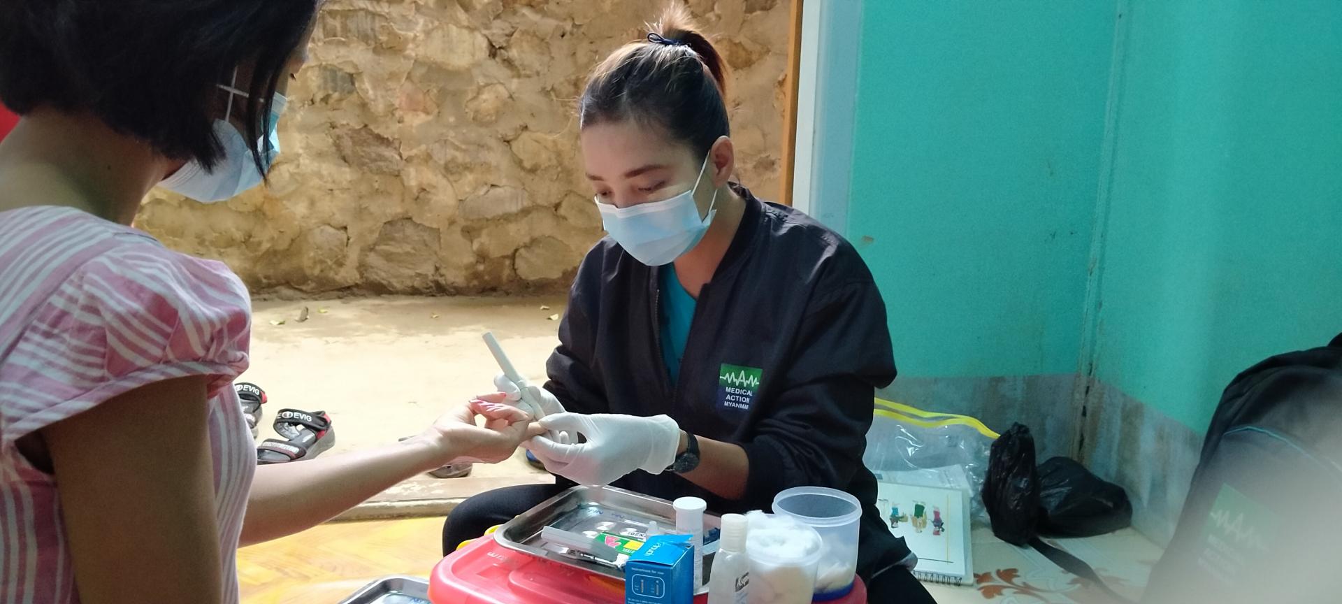 A peer educator conducting HIV case-based surveillance among female sex workers in Hpakant township. Photo: Medical Action Myanmar 
